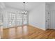Bright dining room with hardwood floors, large windows, and an elegant chandelier at 1303 Angel Falls Sw Ln, Atlanta, GA 30311