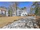 Inviting two-story home with a white exterior, black shutters and a long concrete driveway at 1303 Angel Falls Sw Ln, Atlanta, GA 30311