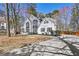 Charming two-story home with a manicured lawn and a long concrete driveway on a sunny day at 1303 Angel Falls Sw Ln, Atlanta, GA 30311