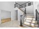 Foyer boasting tile flooring, staircase with iron railing, and access to other rooms at 1303 Angel Falls Sw Ln, Atlanta, GA 30311