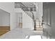 Bright foyer with marble floors, elegant staircase, and modern finishes, creating a grand entrance at 1303 Angel Falls Sw Ln, Atlanta, GA 30311
