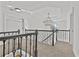 Second floor hallway showcasing carpet, iron railing, and a modern chandelier at 1303 Angel Falls Sw Ln, Atlanta, GA 30311