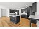 Spacious kitchen with black cabinets, island with white countertop, stainless steel appliances, and hardwood floors at 1303 Angel Falls Sw Ln, Atlanta, GA 30311