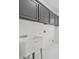 Laundry room with modern upper cabinets and utility sink at 1303 Angel Falls Sw Ln, Atlanta, GA 30311