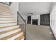 View of the living room with a fireplace, built-in shelving, and a staircase at 1303 Angel Falls Sw Ln, Atlanta, GA 30311