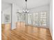 Open living room with hardwood floors, lots of natural light, and a modern chandelier at 1303 Angel Falls Sw Ln, Atlanta, GA 30311