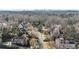 A beautiful neighborhood showcasing a home with manicured lawns, mature trees, and a skyline view at 1386 Wesley Nw Cir, Atlanta, GA 30327