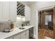 Stylish bar area with custom cabinetry, wine rack, and marble countertops at 1386 Wesley Nw Cir, Atlanta, GA 30327