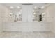 Bright bathroom features double vanity, large mirrors, and custom white cabinets for ample storage space at 1386 Wesley Nw Cir, Atlanta, GA 30327