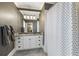 Modern bathroom with white cabinets, neutral grey wallpaper, and a patterned shower curtain at 1386 Wesley Nw Cir, Atlanta, GA 30327