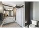 Elegant bathroom with a black and white patterned shower curtain, gray wallpaper, and white cabinets at 1386 Wesley Nw Cir, Atlanta, GA 30327