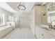 Bright bathroom featuring a soaking tub, glass shower, double vanity and neutral tile at 1386 Wesley Nw Cir, Atlanta, GA 30327