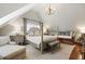 Comfortable bedroom with hardwood floors, chair, and a four poster bed at 1386 Wesley Nw Cir, Atlanta, GA 30327