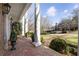 Inviting brick porch featuring classic columns and lush landscaping, creating an elegant entryway at 1386 Wesley Nw Cir, Atlanta, GA 30327
