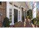 Inviting front entrance with brick path, black door, and classic white trim at 1386 Wesley Nw Cir, Atlanta, GA 30327