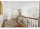 Upstairs hallway showcasing hardwood floors, wainscoting and chandelier at 1386 Wesley Nw Cir, Atlanta, GA 30327