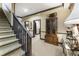 Hallway featuring carpeted stairs, a cabinet with hats, and a decorative table at 1386 Wesley Nw Cir, Atlanta, GA 30327