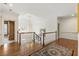 Bright second floor landing with hardwood floors, chandelier, and white railing at 1386 Wesley Nw Cir, Atlanta, GA 30327