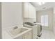 Well-lit laundry room with appliances, built-in cabinets, and ample counter space at 1386 Wesley Nw Cir, Atlanta, GA 30327