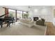 Sun-lit living room features a piano, fireplace, and access to an outdoor patio at 1386 Wesley Nw Cir, Atlanta, GA 30327