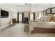 Bright primary bedroom showcasing a four-poster bed, neutral carpet and matching bench at 1386 Wesley Nw Cir, Atlanta, GA 30327