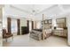 Spacious main bedroom featuring a four-poster bed, tray ceiling, and ample natural light at 1386 Wesley Nw Cir, Atlanta, GA 30327