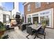 Charming outdoor area featuring a stone fireplace, dining table, and stylish seating, perfect for entertaining at 1386 Wesley Nw Cir, Atlanta, GA 30327