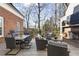Inviting outdoor living space with a brick fireplace and comfortable seating on a spacious wood deck at 1386 Wesley Nw Cir, Atlanta, GA 30327