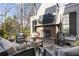 Outdoor lounge area on a wood deck with a brick fireplace and comfortable seating at 1386 Wesley Nw Cir, Atlanta, GA 30327