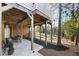 Covered patio with a dining set for outdoor enjoyment of the beautifully landscaped backyard at 1386 Wesley Nw Cir, Atlanta, GA 30327