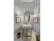 Elegant powder room featuring patterned wallpaper, marble sink, and decorative lighting at 1386 Wesley Nw Cir, Atlanta, GA 30327