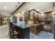 Elegant wet bar with granite countertops, wooden cabinets, and stainless steel appliances at 1386 Wesley Nw Cir, Atlanta, GA 30327