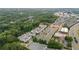 An aerial view of a neighborhood with lush surrounding trees, buildings, and nearby roads at 375 Banbury Xing, Alpharetta, GA 30009