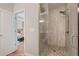 Bathroom featuring a modern shower with stone flooring and a glass door, open to a bedroom view at 375 Banbury Xing, Alpharetta, GA 30009