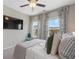 Cozy bedroom with natural lighting, stylish furnishings, and view of a flat-screen TV at 375 Banbury Xing, Alpharetta, GA 30009
