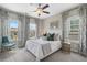 Bright bedroom featuring neutral tones, large windows with patterned curtains, and a comfortable bed at 375 Banbury Xing, Alpharetta, GA 30009