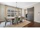 Charming dining area with modern chandelier, large window, and barn door entrance to an office at 375 Banbury Xing, Alpharetta, GA 30009