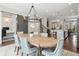 Stunning dining area with hardwood floors, modern chandelier, and view of kitchen and office at 375 Banbury Xing, Alpharetta, GA 30009