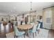 Elegant dining room features an open floor plan, hardwood floors, and a modern chandelier at 375 Banbury Xing, Alpharetta, GA 30009