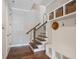 Welcoming entryway featuring wood floors, storage shelves, and a staircase with iron spindles at 375 Banbury Xing, Alpharetta, GA 30009