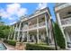 Two-story home with a charming front porch and balcony, perfect for enjoying the outdoors in style at 375 Banbury Xing, Alpharetta, GA 30009