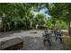 Outdoor firepit area with gravel, seating and mature trees offers a relaxing spot for residents and guests at 375 Banbury Xing, Alpharetta, GA 30009