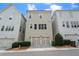 Rear exterior view of townhome with a two-car garage at 375 Banbury Xing, Alpharetta, GA 30009