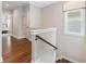 Upstairs hallway features hardwood floors, natural light, and access to various rooms at 375 Banbury Xing, Alpharetta, GA 30009