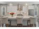 Well-appointed kitchen featuring an island with seating, modern pendant lighting, and stainless steel appliances at 375 Banbury Xing, Alpharetta, GA 30009