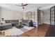 Cozy living room features a sectional sofa, area rug, and modern ceiling fan at 375 Banbury Xing, Alpharetta, GA 30009