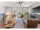 Cozy living room featuring hardwood floors, modern furniture, and large windows providing natural light at 375 Banbury Xing, Alpharetta, GA 30009