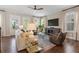 Well-lit living room with modern decor and hardwood floors, showcasing a comfortable and inviting space at 375 Banbury Xing, Alpharetta, GA 30009
