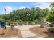 A welcoming archway leads to Thompson Street Park with trees and pond, offering a tranquil escape for residents at 375 Banbury Xing, Alpharetta, GA 30009