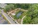 Scenic aerial view of a pond, lush greenery, walking paths, and the adjacent residential area at 375 Banbury Xing, Alpharetta, GA 30009